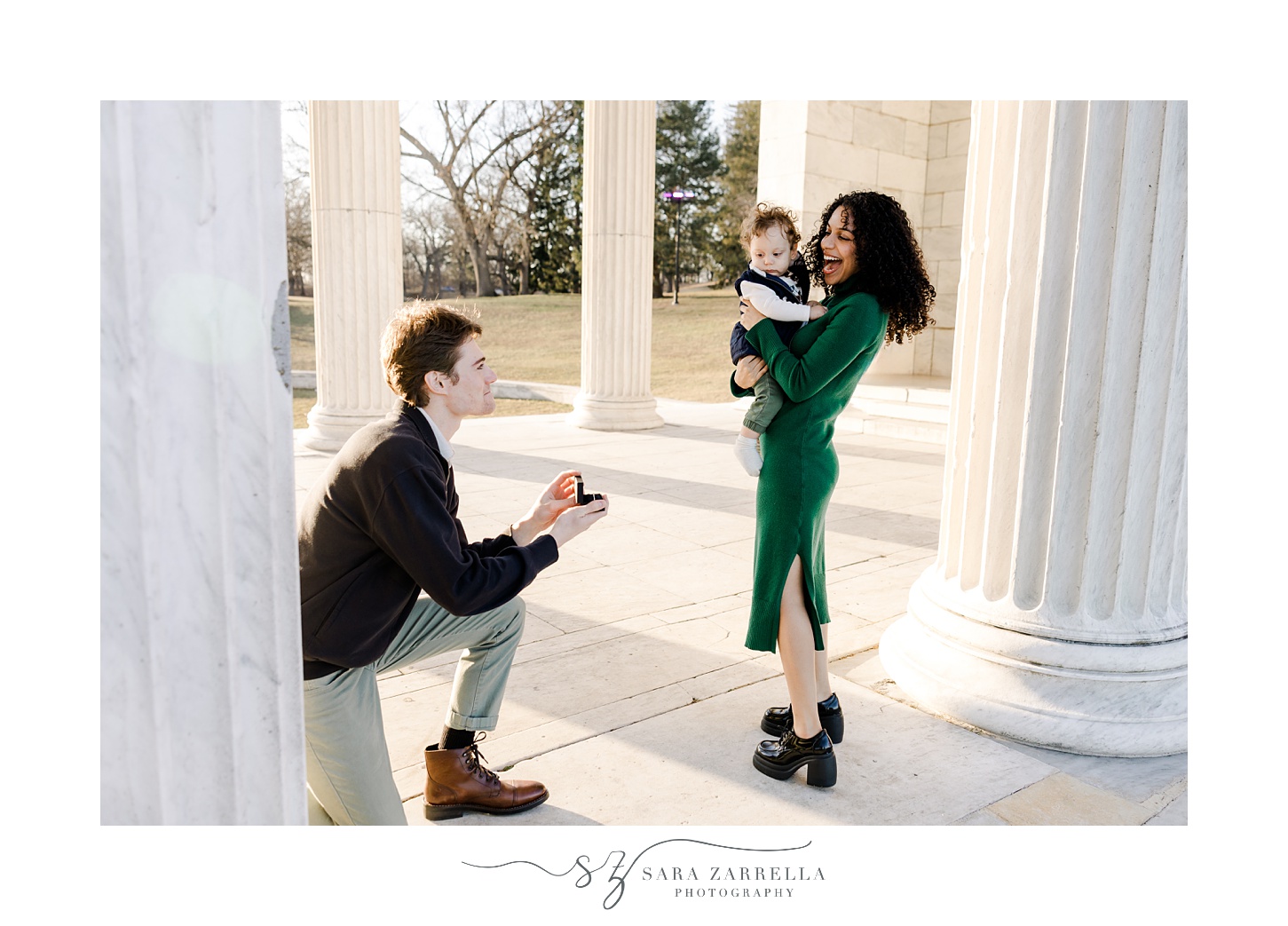 man holds out ring to woman during proposal at Roger Williams Park