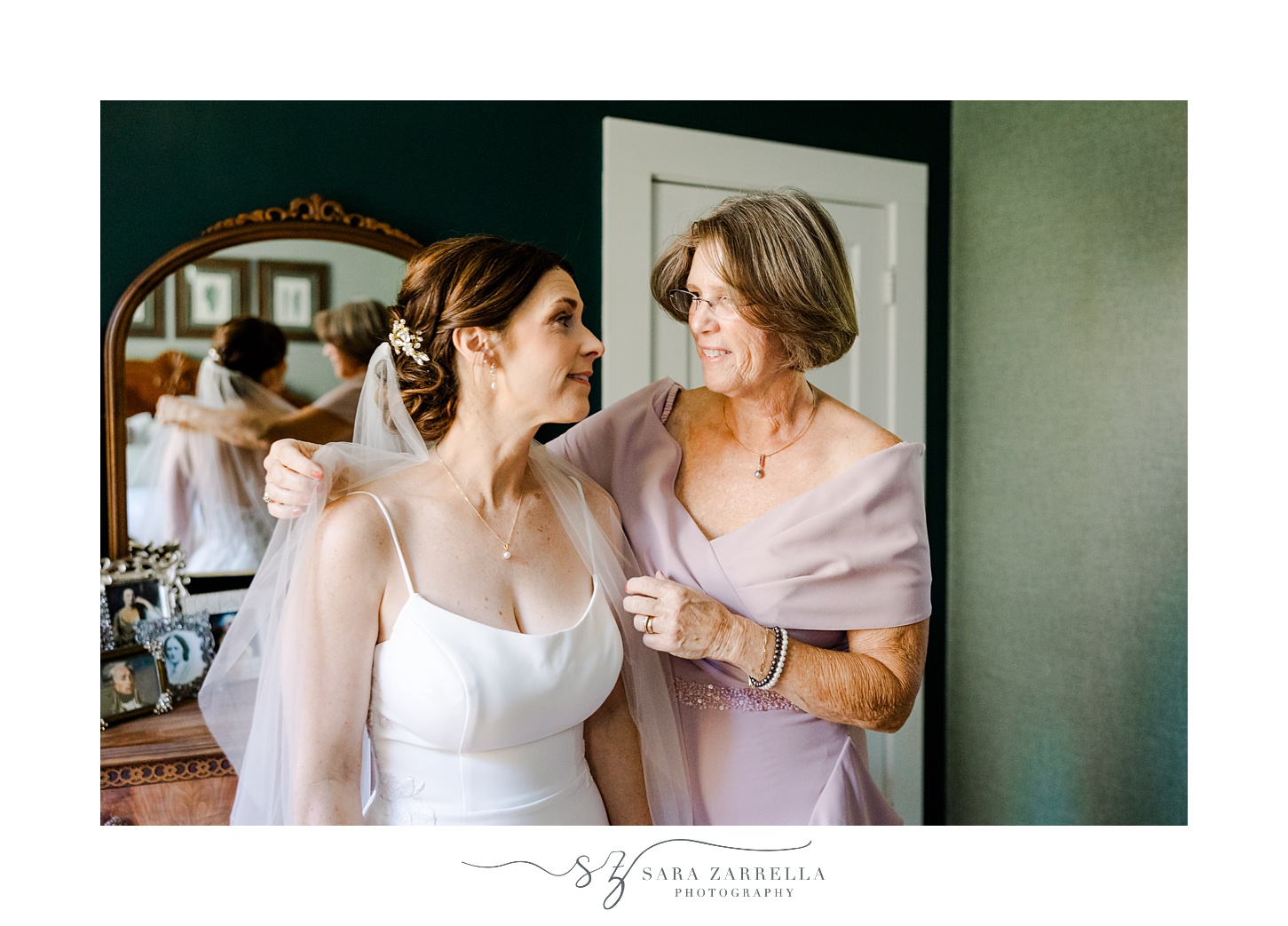 mother and bride talk while she adjust veil during fall wedding day in North Kingstown RI