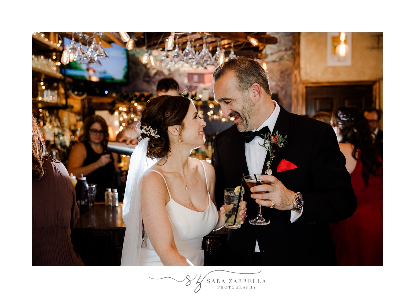 newlyweds smile at each other inside Main Street Coffee in East Greenwich RI