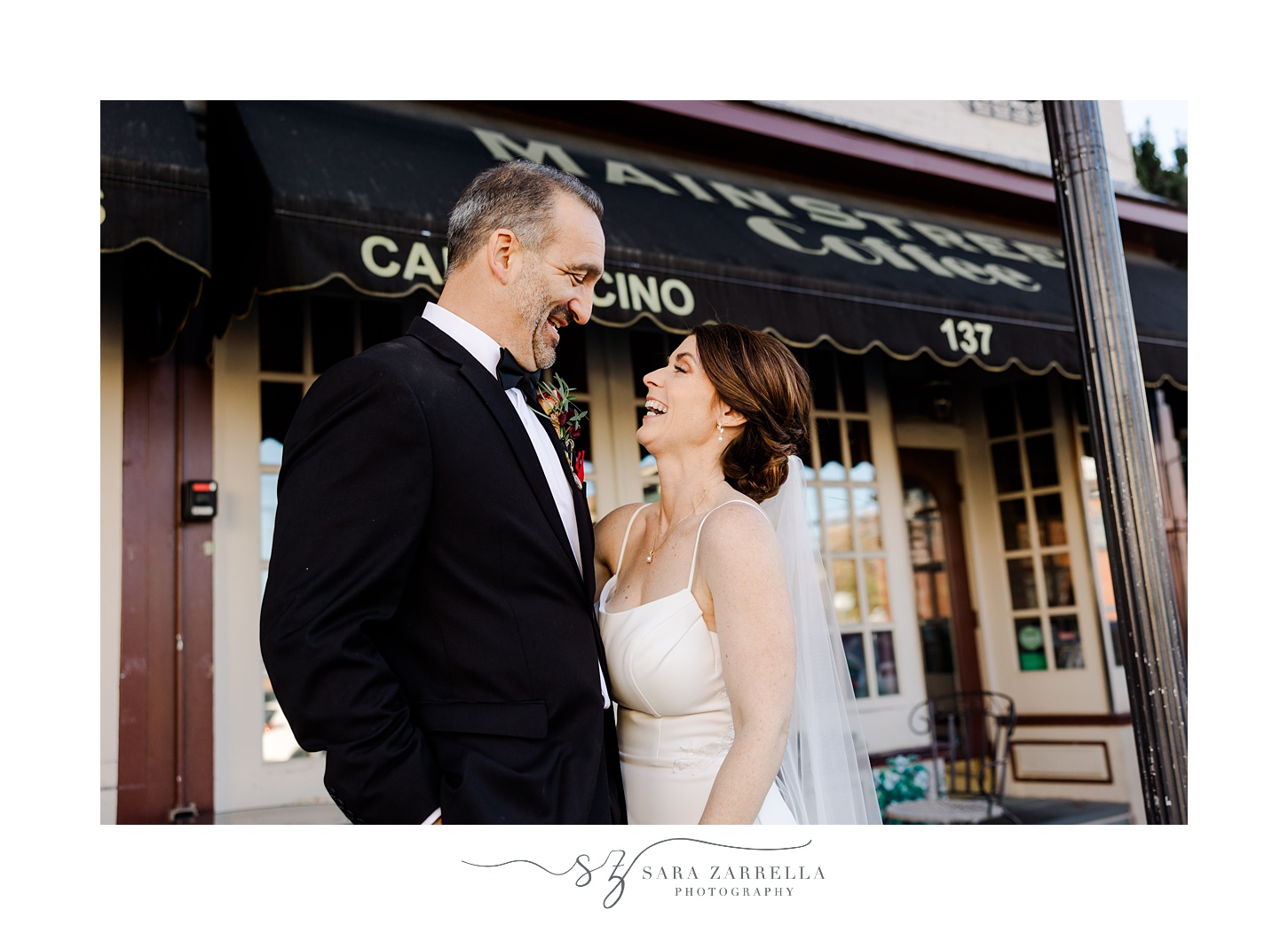 bride and groom smile outside Main Street Coffee in East Greenwich RI