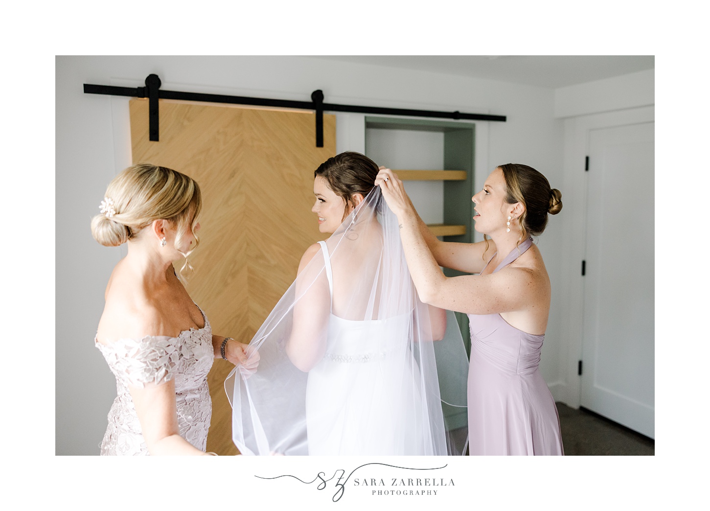 bridesmaids place veil in bride's hair in suite at Shepard's Run