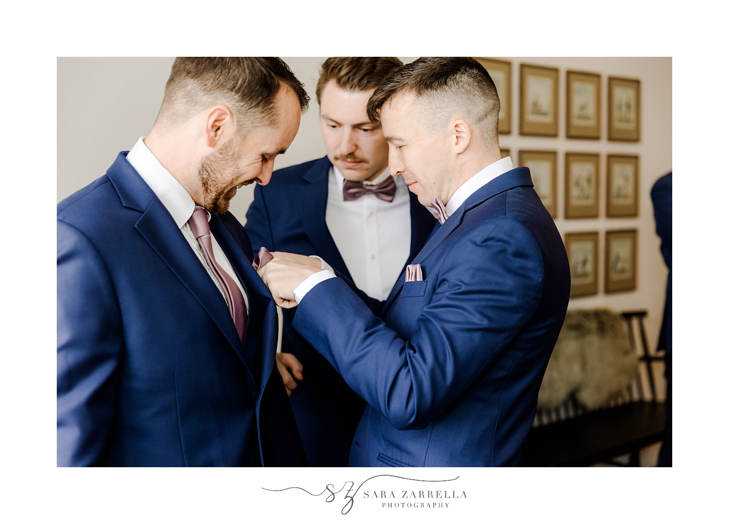 groomsmen help groom adjust pocket square inside groom suite at Shepard's Run