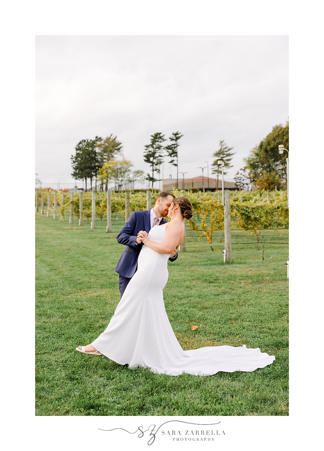newlyweds kiss in front of vineyard in South Kingstown RI