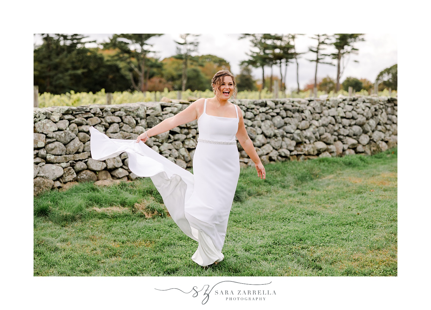 bride twirls in front of stone wall in South Kingstown RI