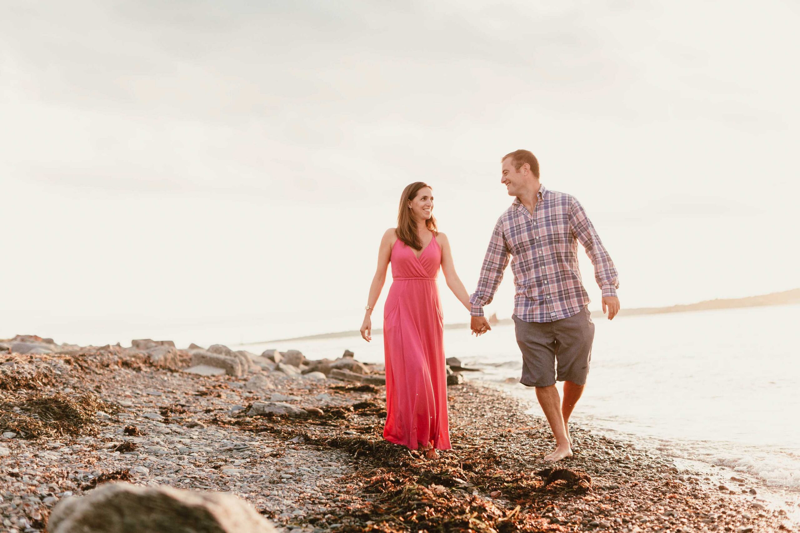 Newly Engaged Couple Walking Along Shore in Newport