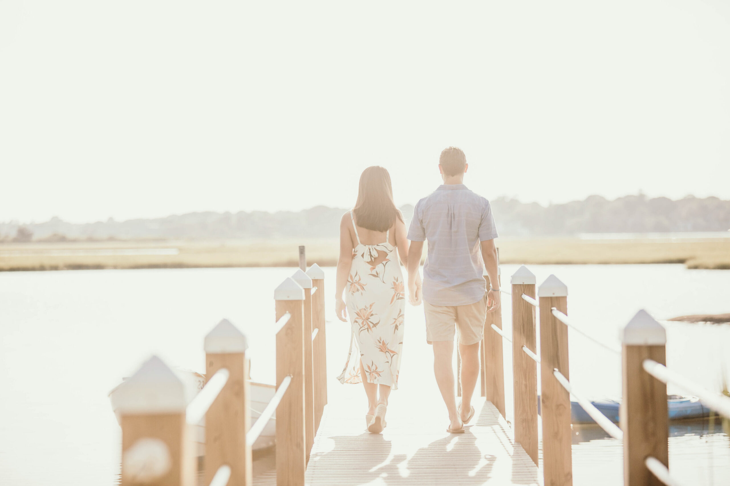 Newly Engaged Couple Walking Along Pier in Newport