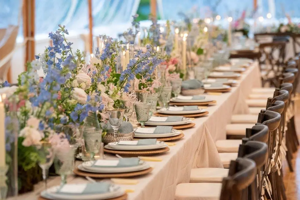 Reception dinner table with rentals used. Rentals for weddings. Wedding planning podcast