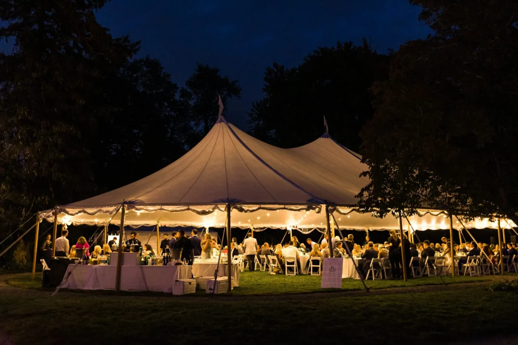 Evening outdoor wedding reception tent. Wedding tent. Wedding planning podcast tips 